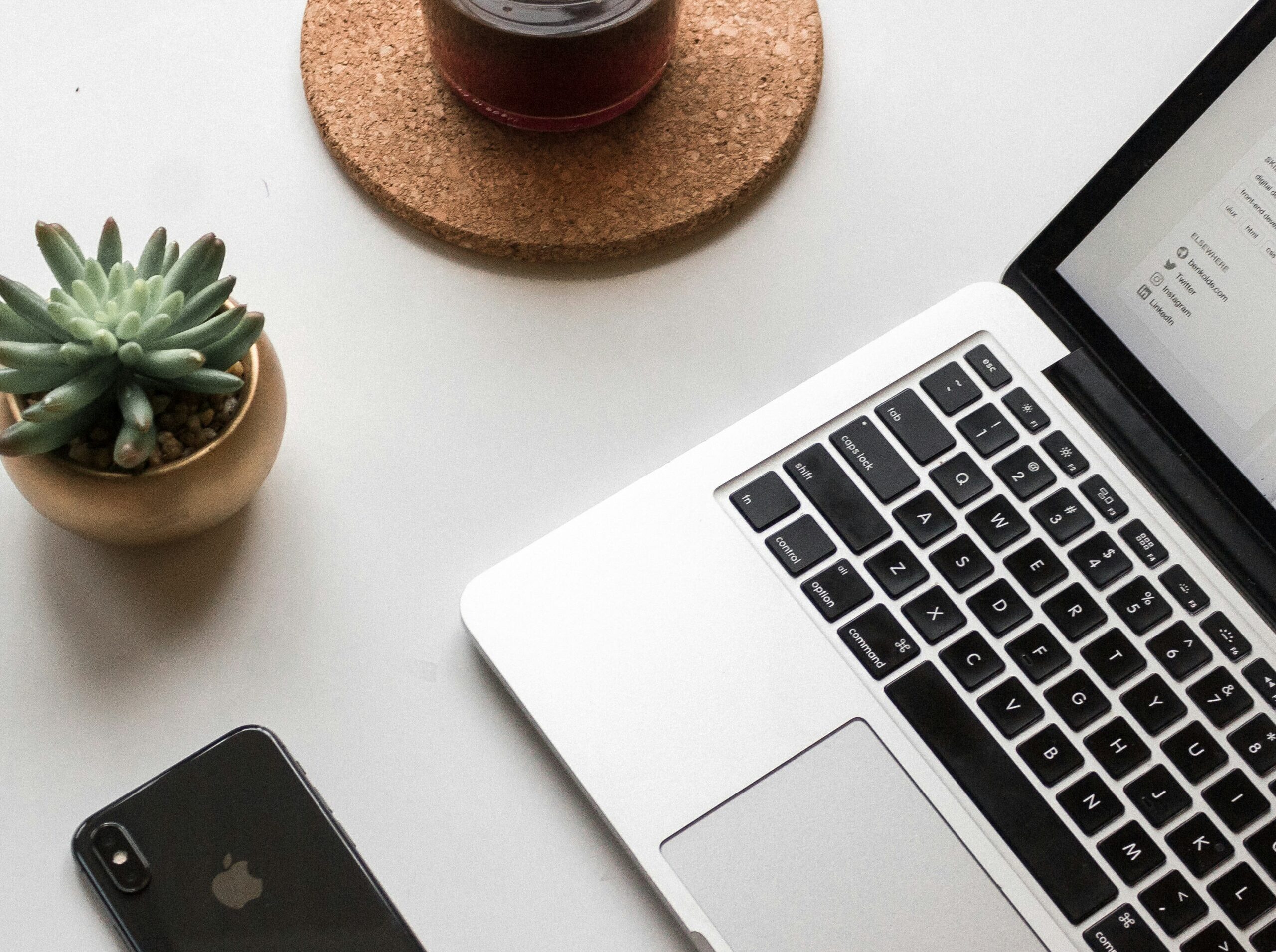 MacBook with styled workspace — content creation and brand design workflow